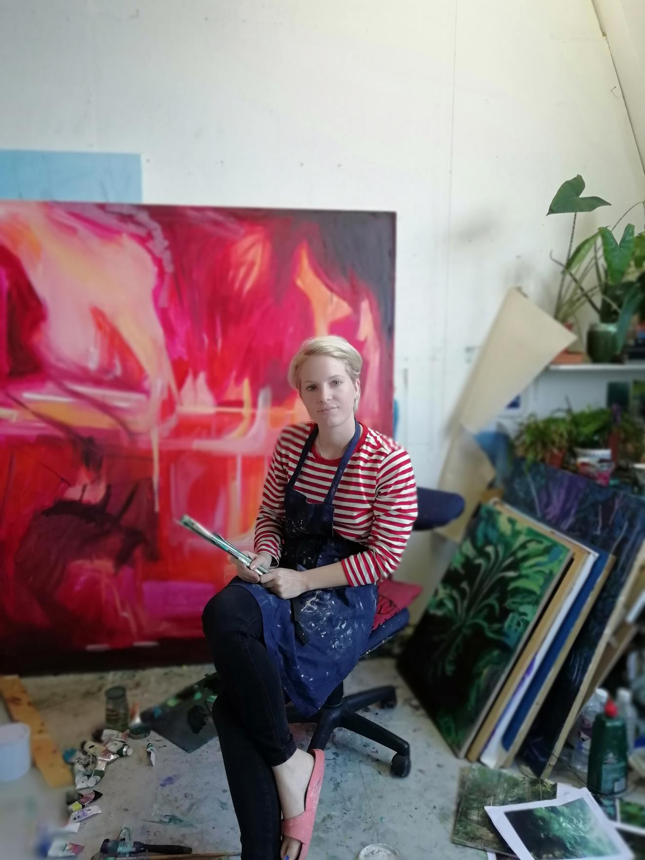 The artist Lucy Smallbone sitting in front of her work
