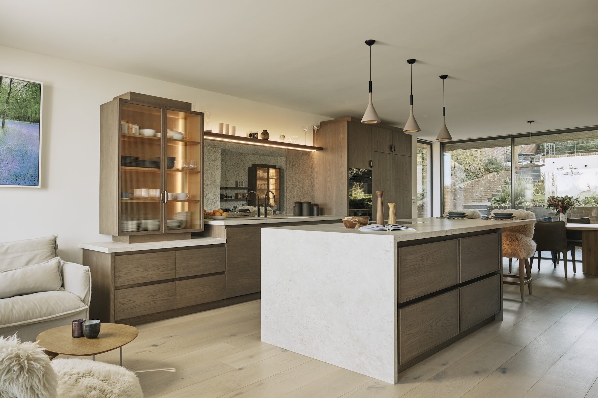 Dark oak cabinetry and marble island in Sussex Kitchen 