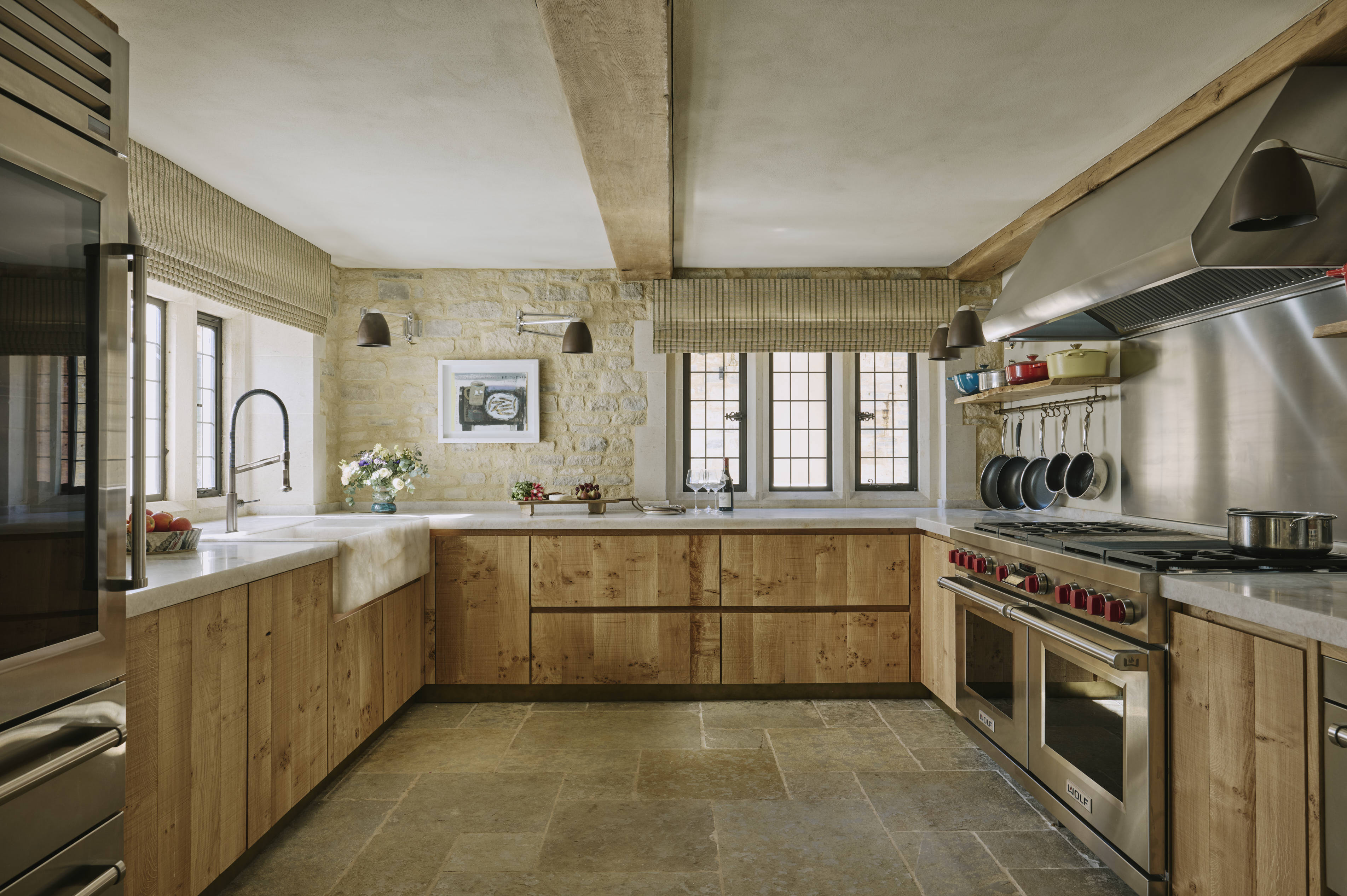 Textured crown oak cabinetry contrasts with the smooth Diamond Quartzite worktops and sink.
