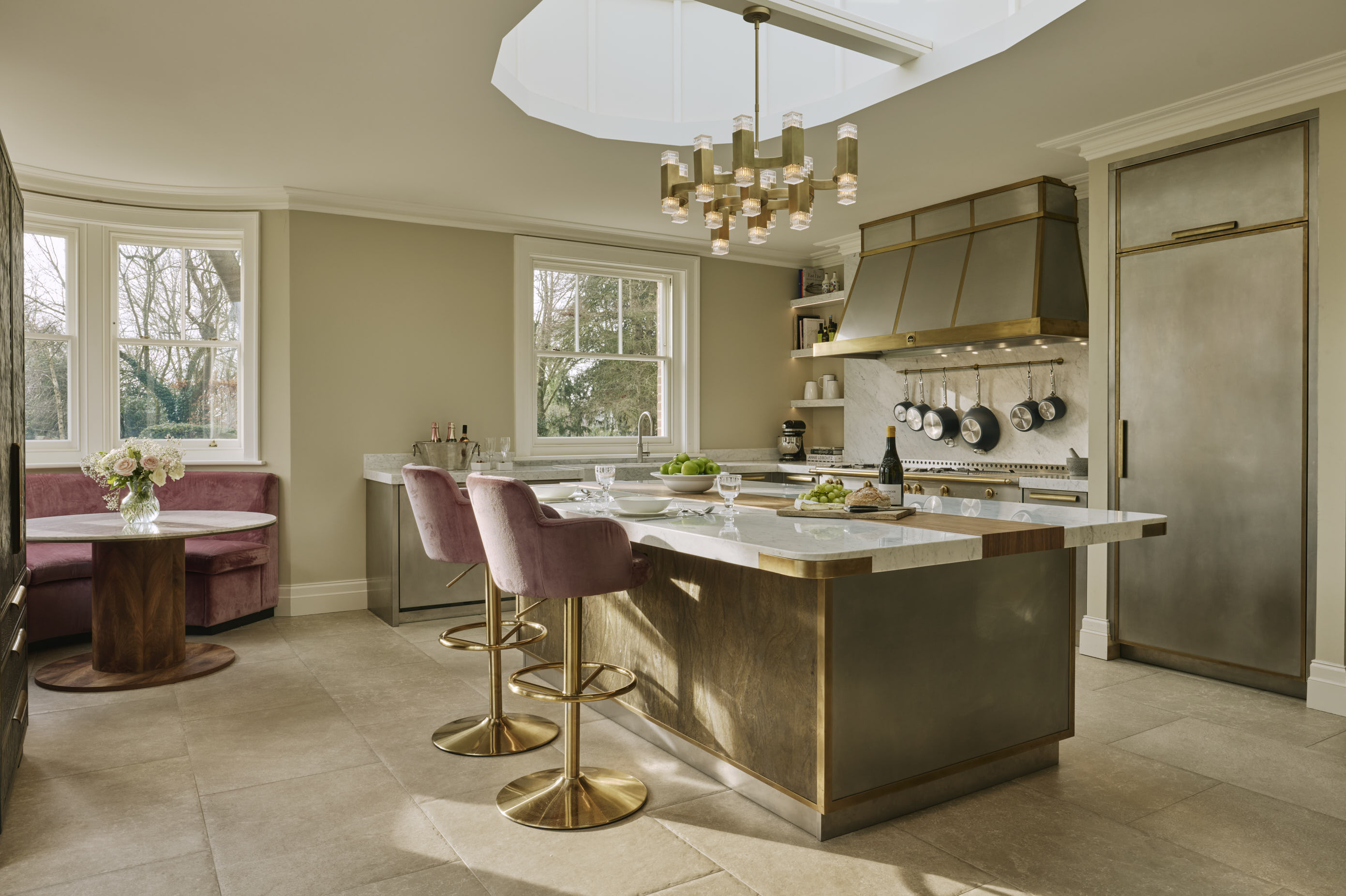The Oxford kitchen featuring brushed stainless steel with brass detailing, marble and timber.