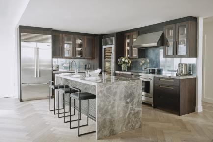 Canary Wharf Kitchen by Ledbury Studio featuring quartz island and dark stained oak